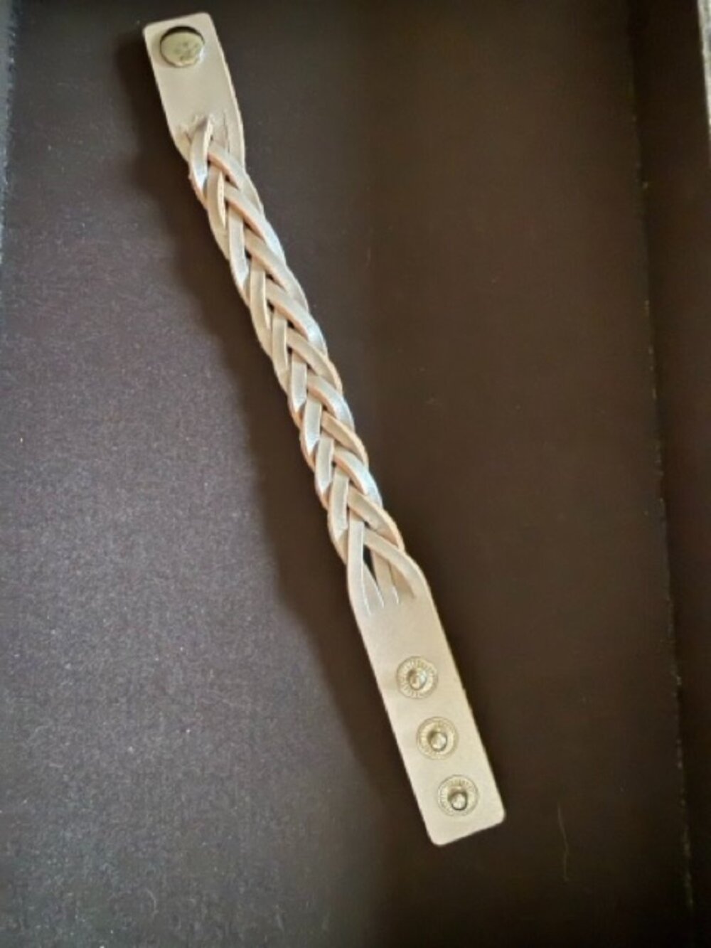 Mystery braid bracelet featuring an adjustable three-snap closure